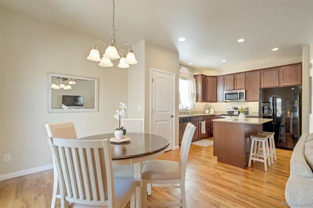 a kitchen with a sink cabinets and wooden floor