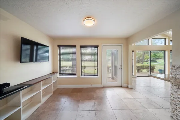 a view of an empty room with window and cabinet