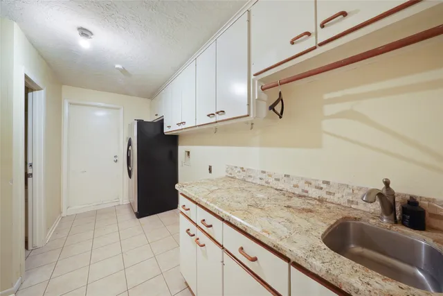 a kitchen with a sink and cabinets