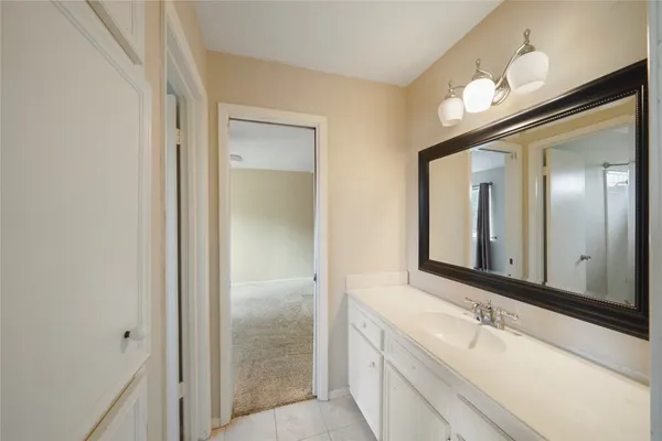 a bathroom with a bathtub a sink and a mirror