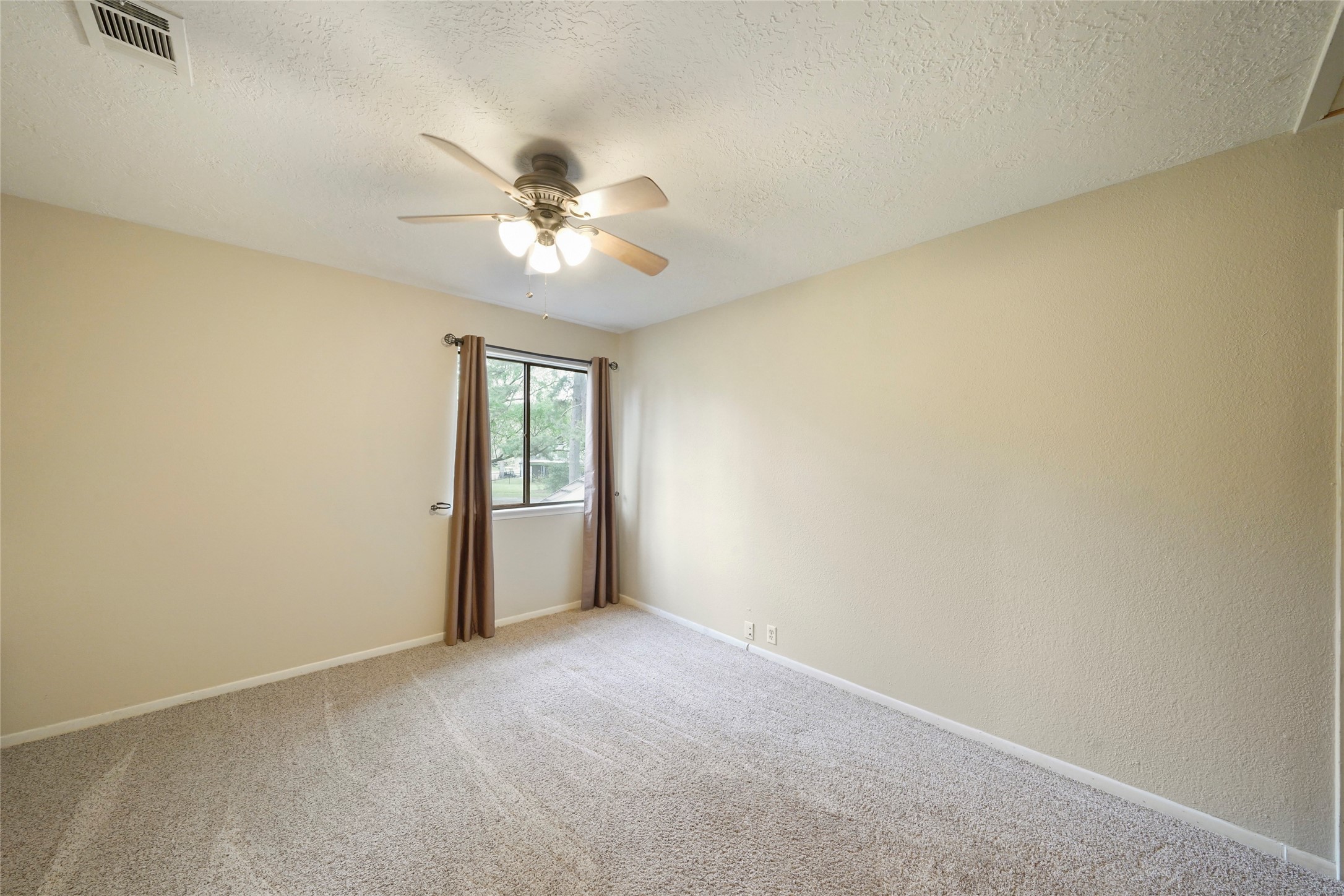 84 April Wind Drive South Conroe, TX 77356 - Photo 32 of 36 an empty room with windows and fan