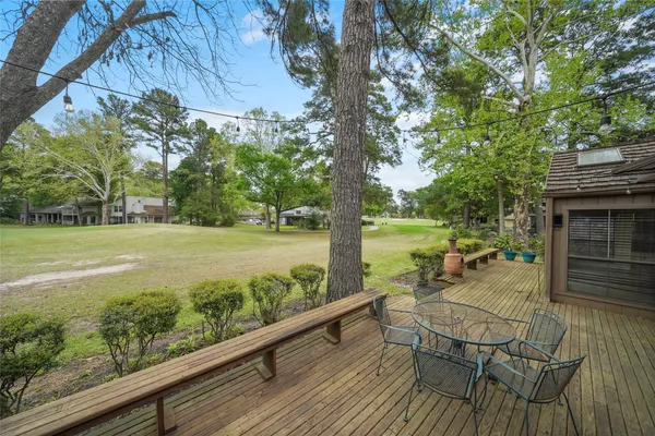 a view of a chairs and table on the wooden deck