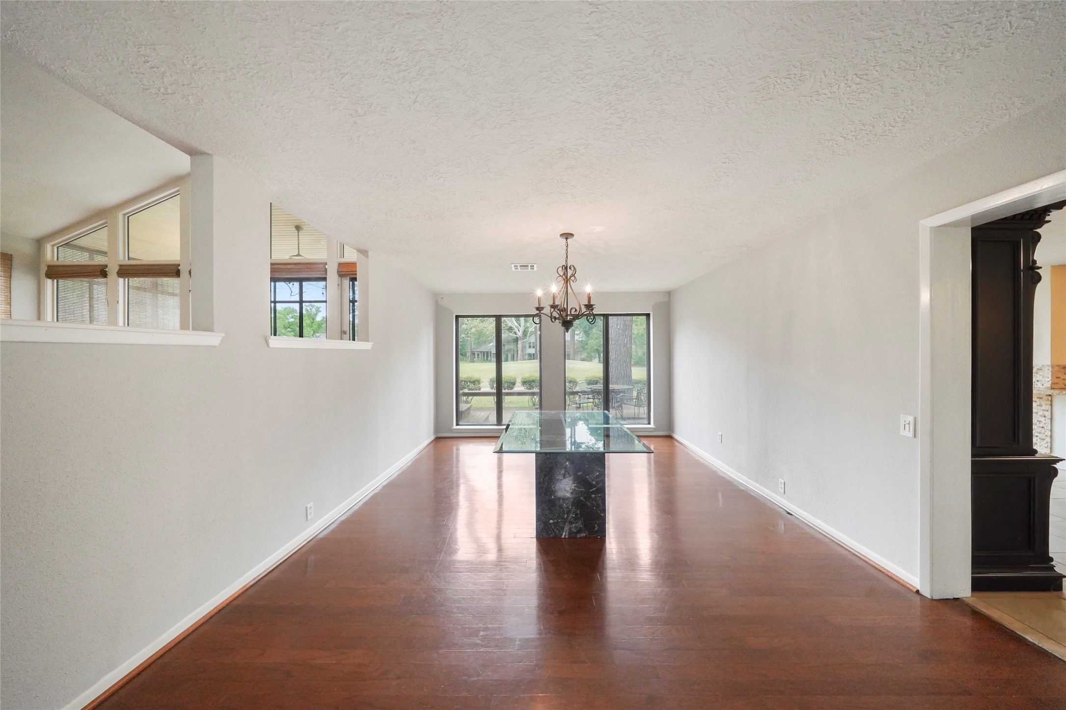 84 April Wind Drive South Conroe, TX 77356 - Photo 8 of 36 an empty room with wooden floor and windows