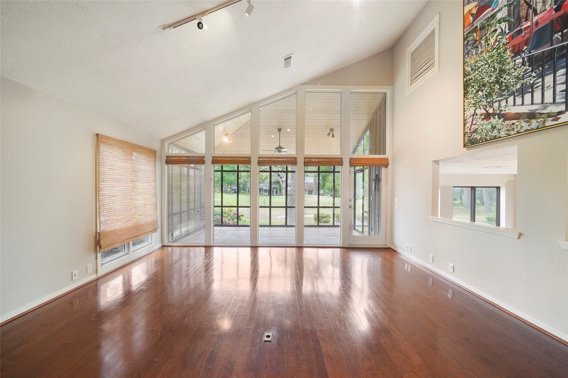 84 April Wind Drive South Conroe, TX 77356 - Photo 9 of 36 a view of an empty room with wooden floor and a window