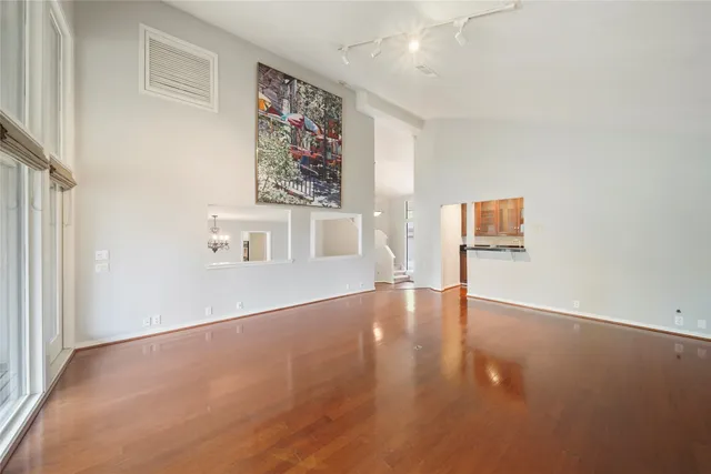 an empty room with windows and cabinet