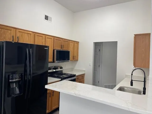a kitchen with a refrigerator and a sink