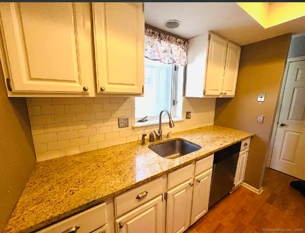 a kitchen with a sink and a window