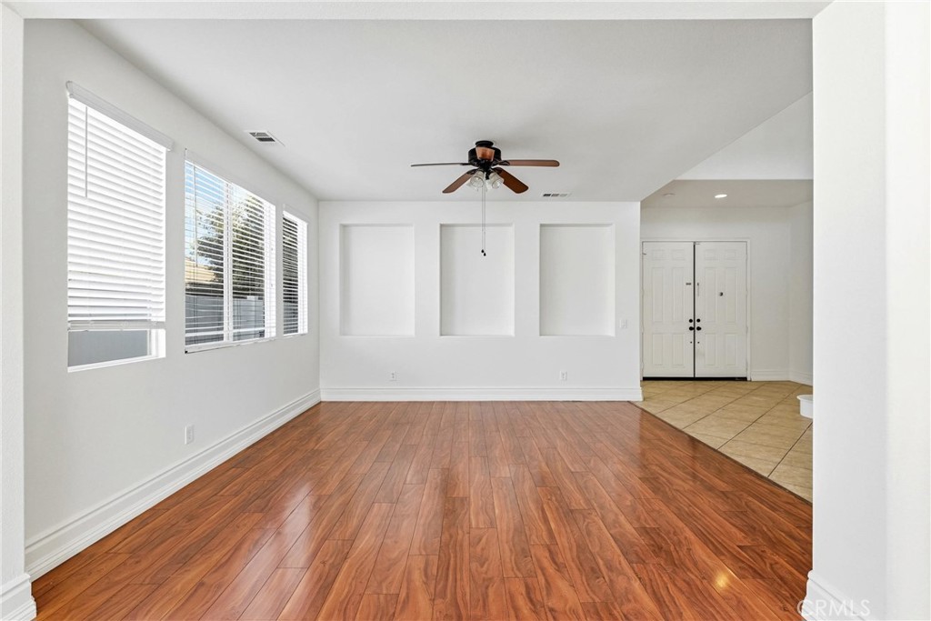28799 First Star Court Menifee, CA 92584 - Photo 11 of 70 a view of an empty room with wooden floor and a window