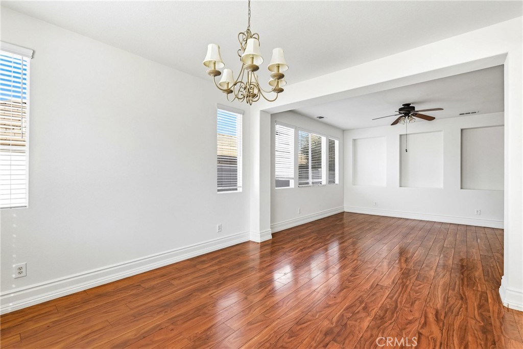 28799 First Star Court Menifee, CA 92584 - Photo 13 of 70 a view of an empty room with wooden floor and a window