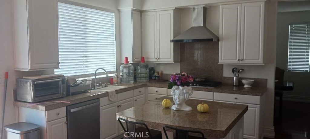 28799 First Star Court Menifee, CA 92584 - Photo 16 of 19 a kitchen with granite countertop a sink a stove and cabinets