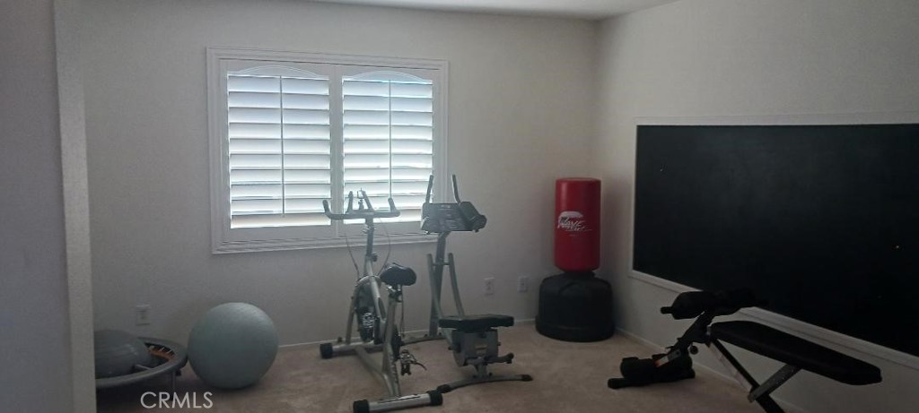 28799 First Star Court Menifee, CA 92584 - Photo 18 of 19 a room with gym equipment and windows