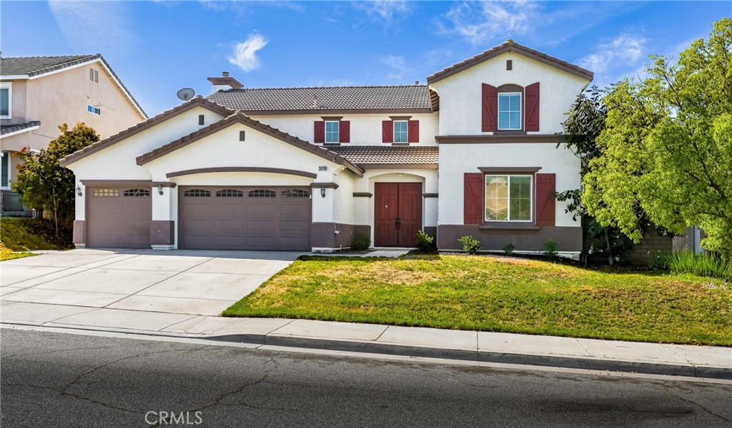 28799 First Star Court Menifee, CA 92584 - Photo 2 of 70 a front view of a house with a yard and garage