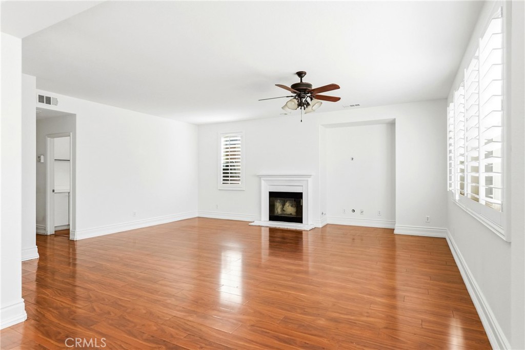28799 First Star Court Menifee, CA 92584 - Photo 24 of 70 a view of empty room with wooden floor and fireplace