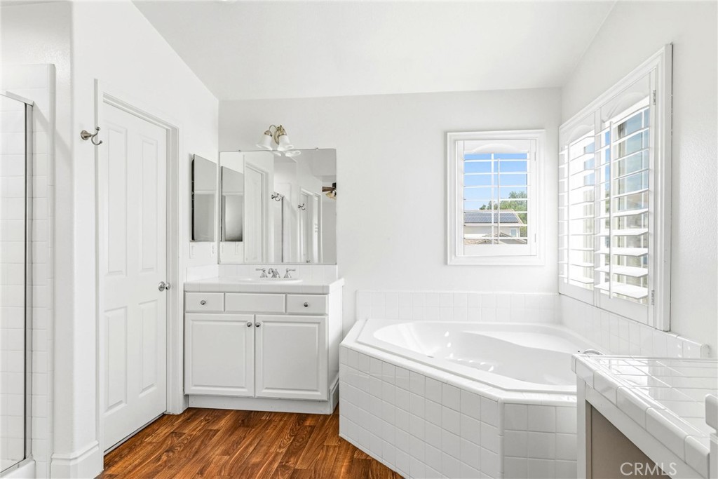 28799 First Star Court Menifee, CA 92584 - Photo 37 of 70 a bathroom with a granite countertop sink a bathtub and shower