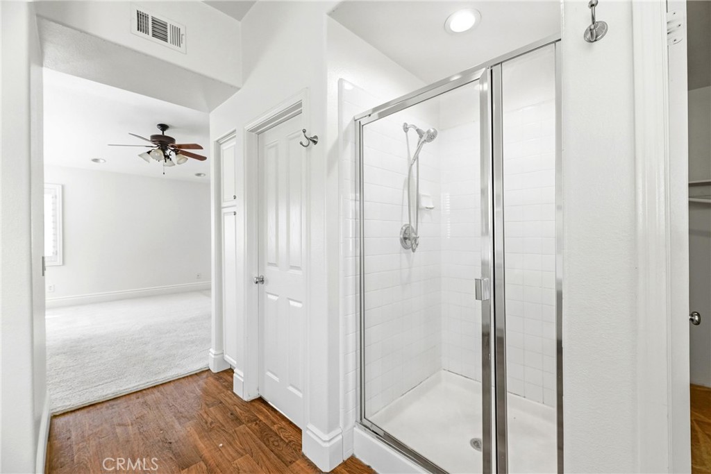 28799 First Star Court Menifee, CA 92584 - Photo 40 of 70 a bathroom with a glass shower door and a bathtub