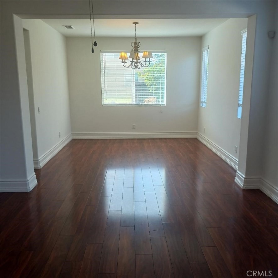 28799 First Star Court Menifee, CA 92584 - Photo 5 of 19 an empty room with wooden floor and windows