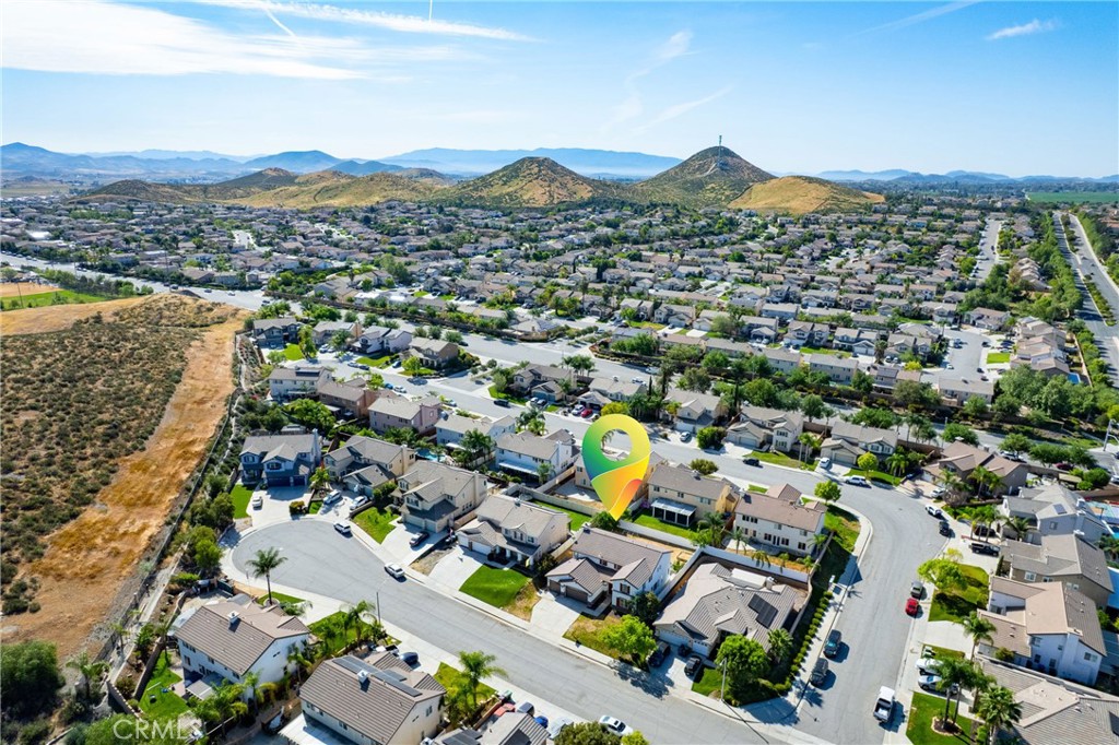 28799 First Star Court Menifee, CA 92584 - Photo 65 of 70 an aerial view of a city with lots of residential buildings and mountain view in back