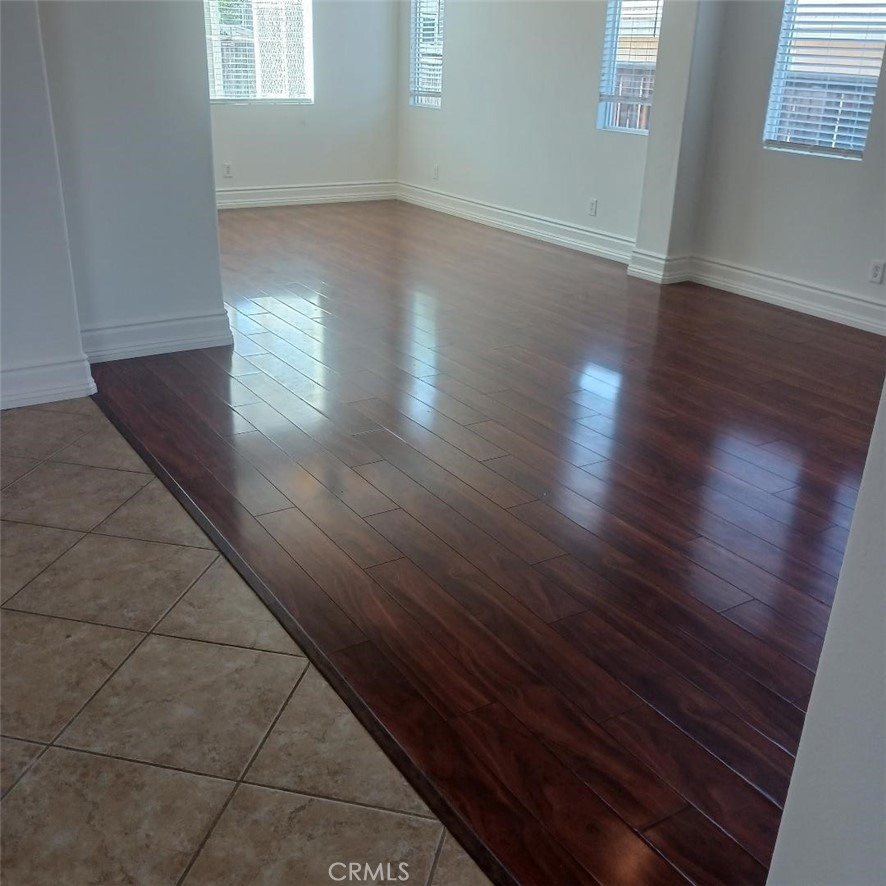 28799 First Star Court Menifee, CA 92584 - Photo 7 of 19 an empty room with wooden floor and windows