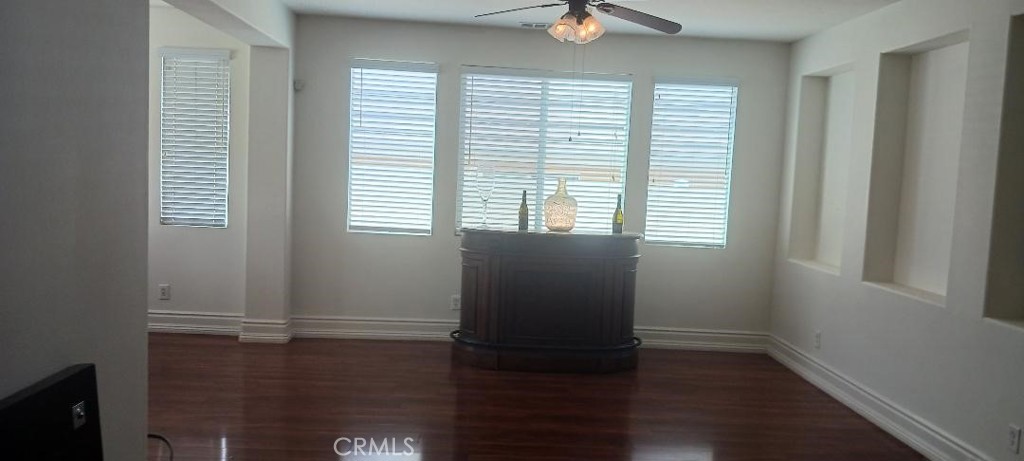 28799 First Star Court Menifee, CA 92584 - Photo 8 of 19 a view of an empty room with wooden floor and a window