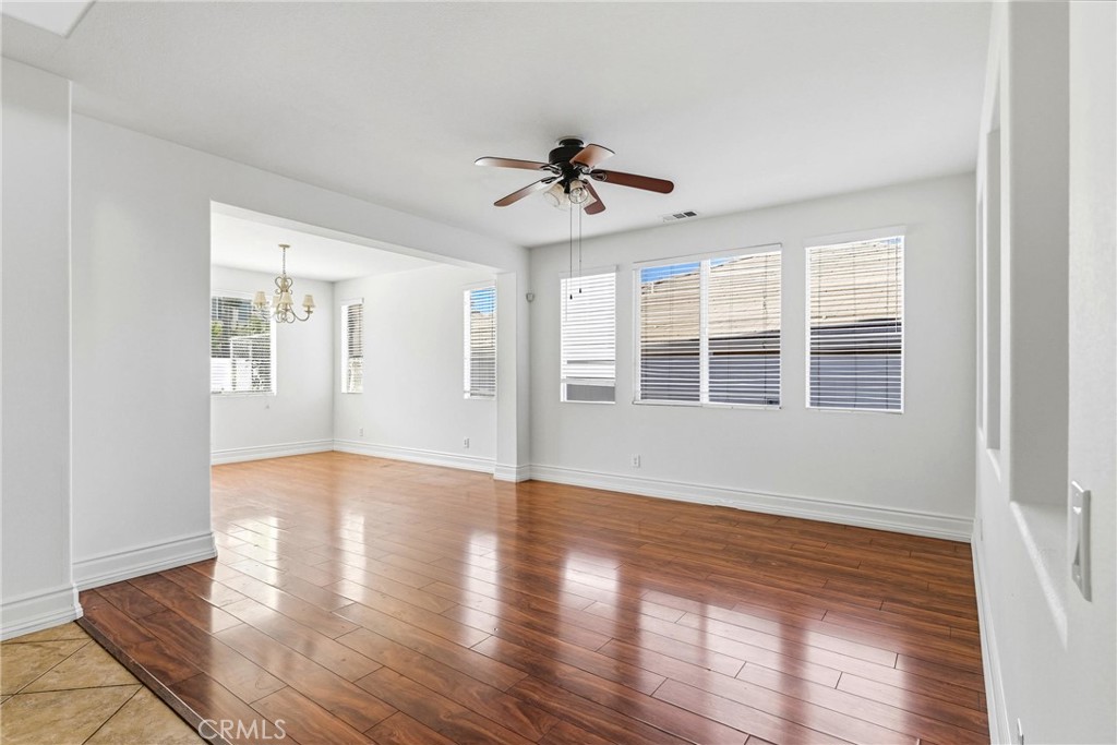 28799 First Star Court Menifee, CA 92584 - Photo 8 of 70 a view of an empty room with wooden floor and a window