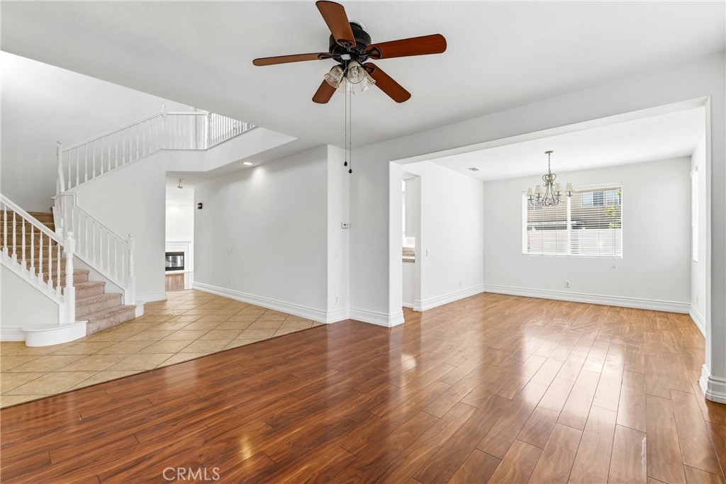 28799 First Star Court Menifee, CA 92584 - Photo 9 of 70 a view of an empty room with wooden floor and a ceiling fan