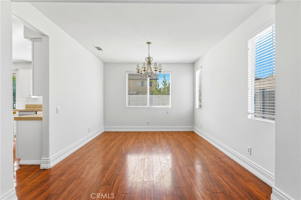 28799 First Star Court Menifee, CA 92584 - Photo 10 of 70 a view of an empty room with wooden floor and a window