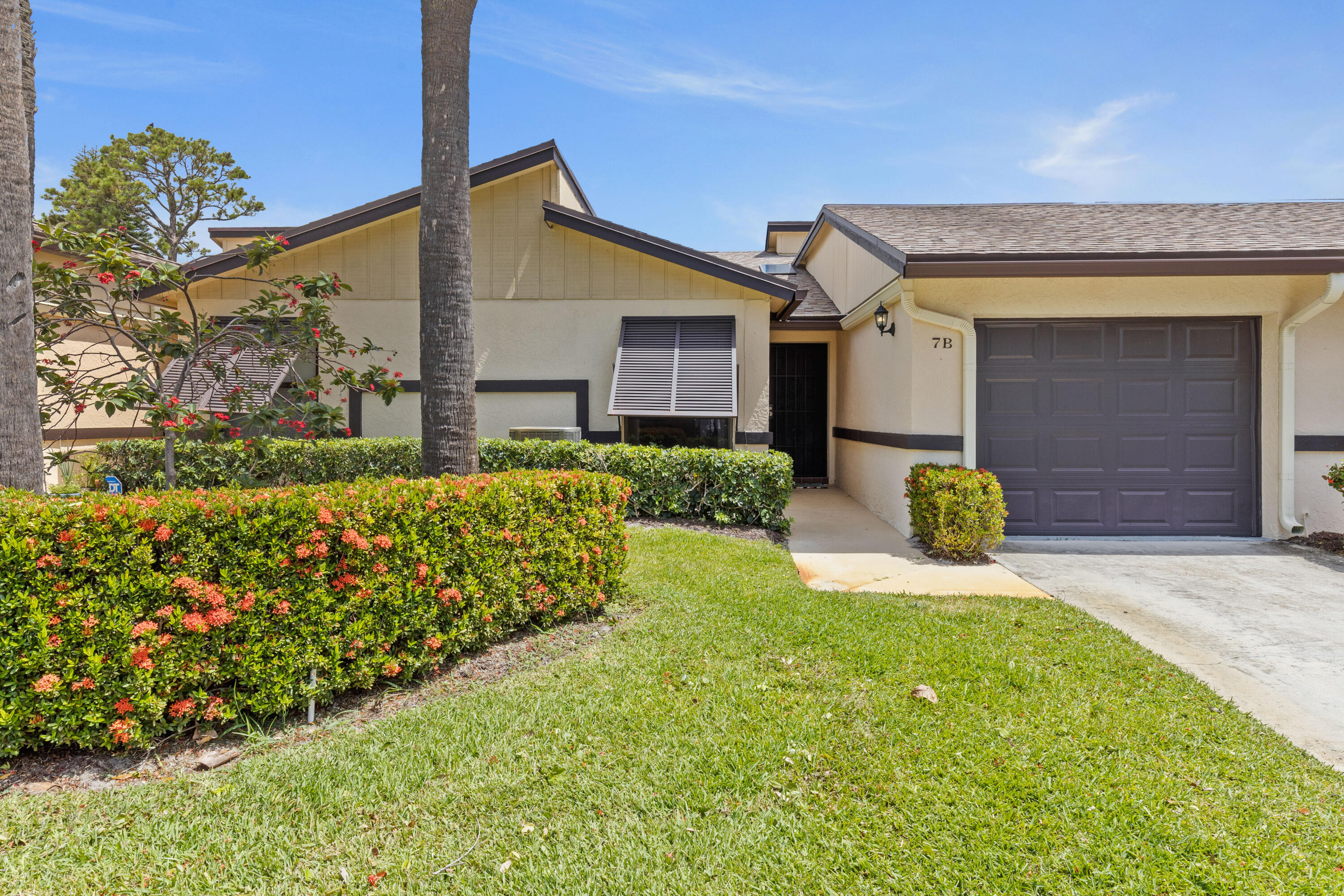 7 Ridge Pointe Drive, Unit B Boynton Beach, FL 33435 - Photo 1 of 25 a front view of a house with garden