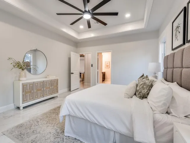 a bedroom with a bed a mirror and furniture