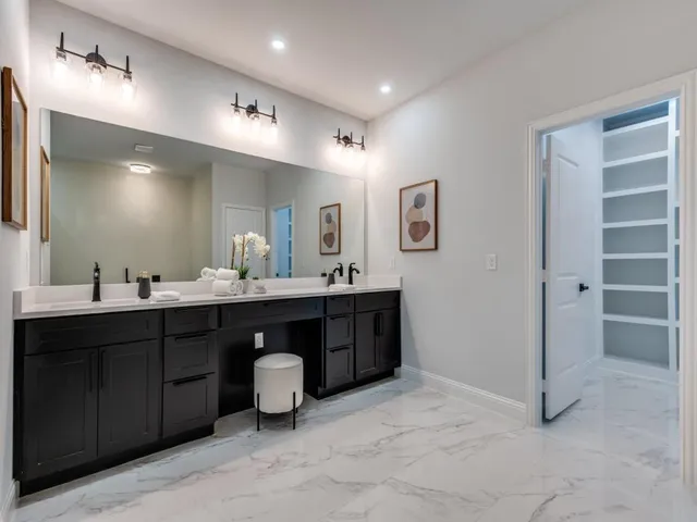 a spacious bathroom with a double vanity sink double and mirror