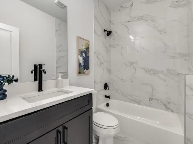 a bathroom with a sink a toilet and a bathtub