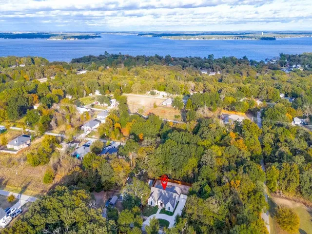 an aerial view of residential house with outdoor space and lake view