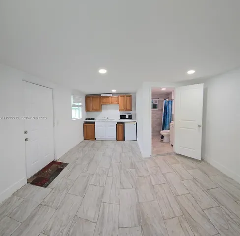 a view of a kitchen with a sink and a refrigerator