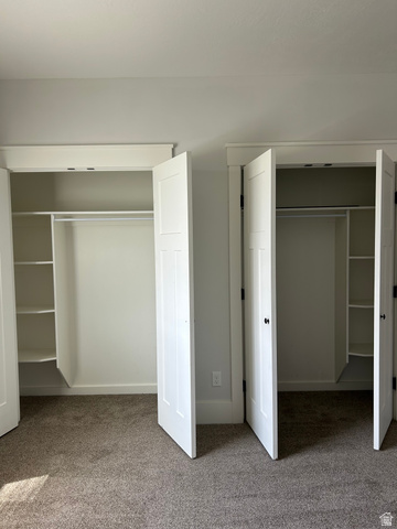 175 North 100th West Centerfield, UT 84622 - Photo 19 of 32 Master Bedroom closet. Dual closets featuring two-panel doors, white trim, and built-in shelving units