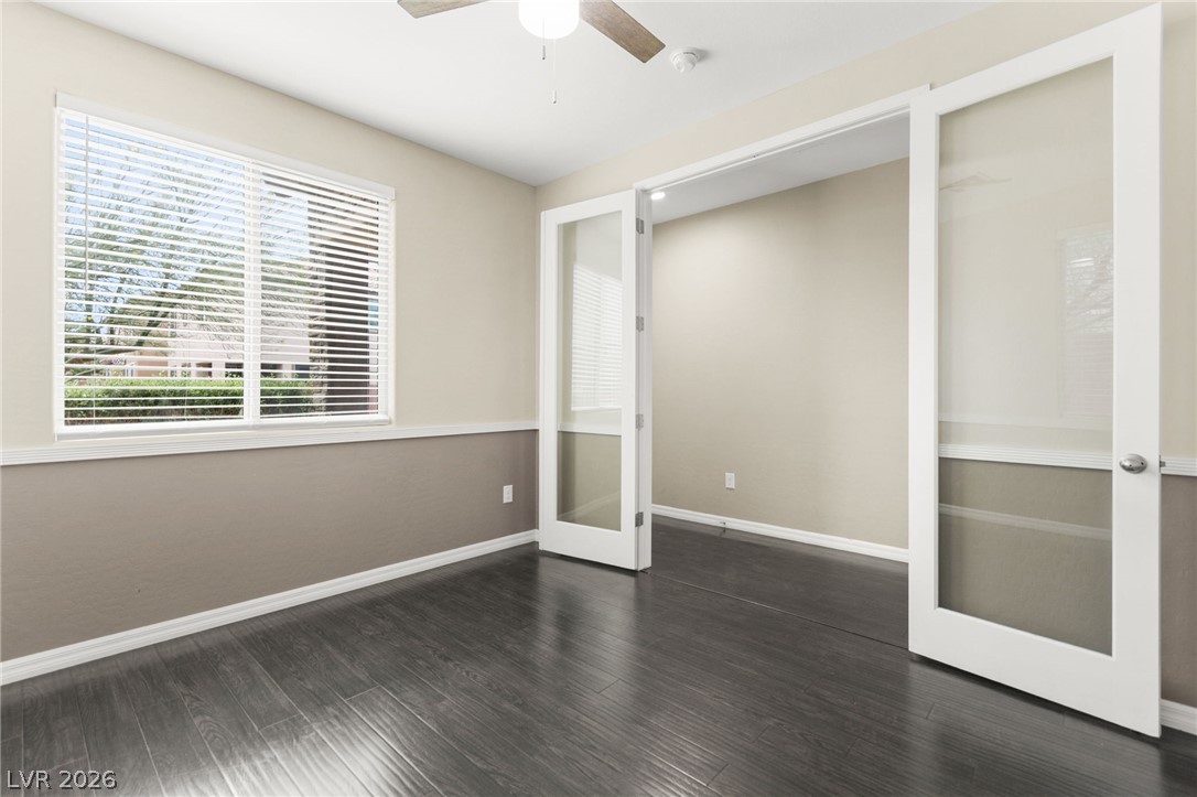 11048 Prairie Grove Road Las Vegas, NV 89179 - Photo 34 of 75 A well-lit room offers rich dark flooring and convenient access through French doors.