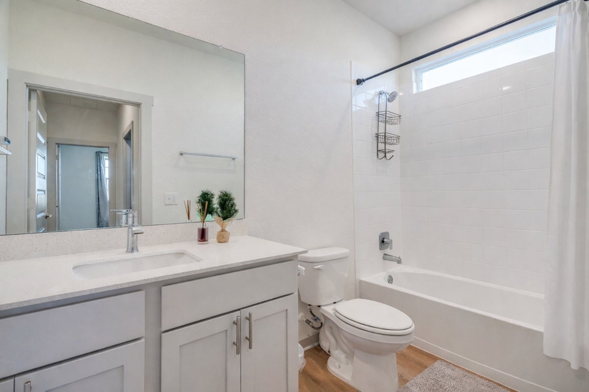 10932 Defender Trail Austin, TX 78754 - Photo 15 of 35 a bathroom with a sink a toilet and shower