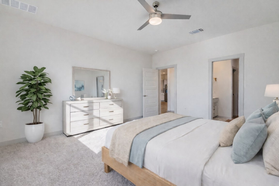 10932 Defender Trail Austin, TX 78754 - Photo 17 of 35 a bed room with a bed and a potted plant