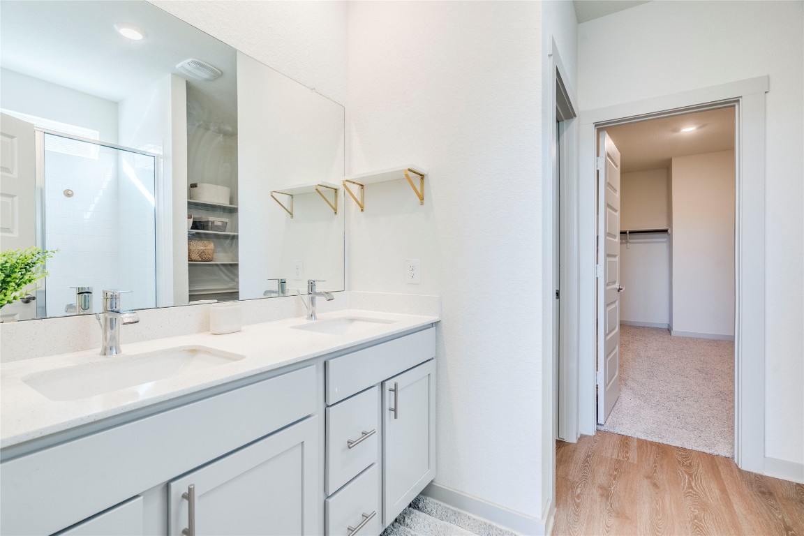 10932 Defender Trail Austin, TX 78754 - Photo 18 of 35 a bathroom with a sink and a mirror