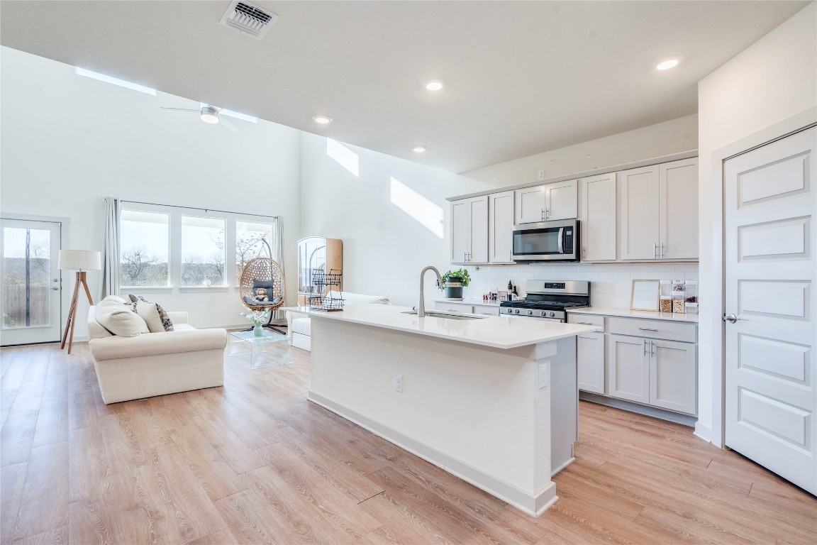 10932 Defender Trail Austin, TX 78754 - Photo 5 of 35 a kitchen with white cabinets and appliances