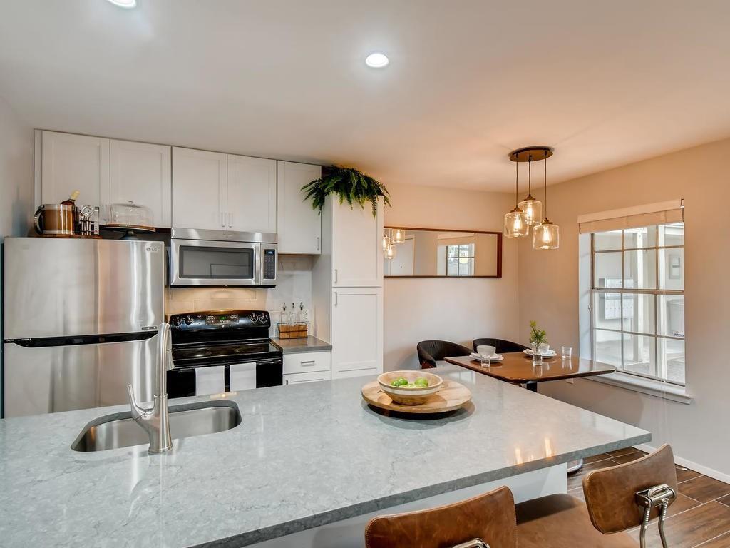 910 Duncan Lane, Unit 16 Austin, TX 78705 - Photo 1 of 15 a kitchen with stainless steel appliances granite countertop a sink stove and refrigerator