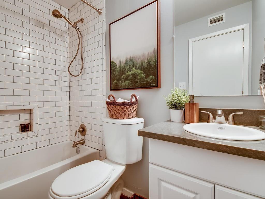 910 Duncan Lane, Unit 16 Austin, TX 78705 - Photo 11 of 15 a bathroom with a granite countertop toilet sink and mirror