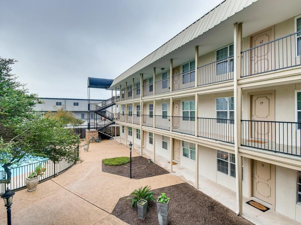 910 Duncan Lane, Unit 16 Austin, TX 78705 - Photo 15 of 15 a house with potted plants in front of it