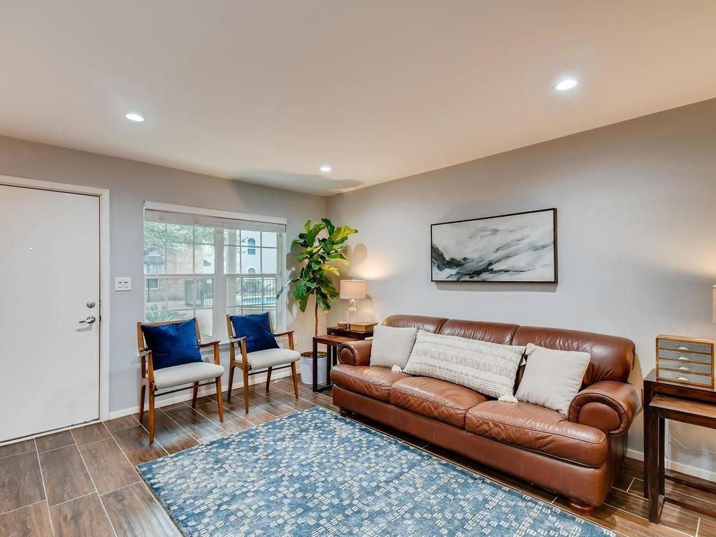 910 Duncan Lane, Unit 16 Austin, TX 78705 - Photo 2 of 15 a living room with furniture and a potted plant