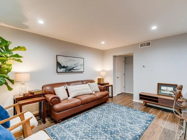 a living room with furniture and a rug