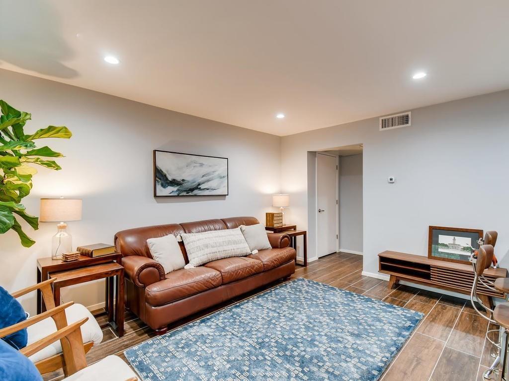 910 Duncan Lane, Unit 16 Austin, TX 78705 - Photo 3 of 15 a living room with furniture and a rug