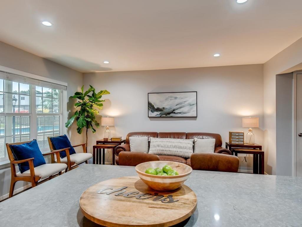 910 Duncan Lane, Unit 16 Austin, TX 78705 - Photo 4 of 15 a living room with furniture and a large window