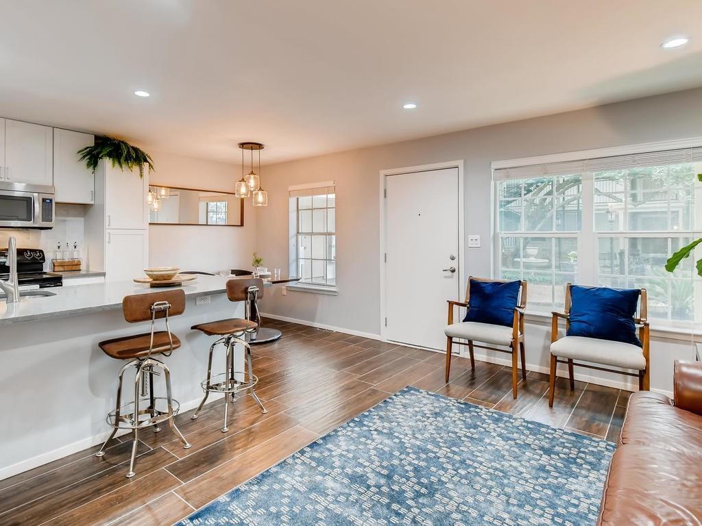 910 Duncan Lane, Unit 16 Austin, TX 78705 - Photo 5 of 15 a living room with furniture and a wooden floor