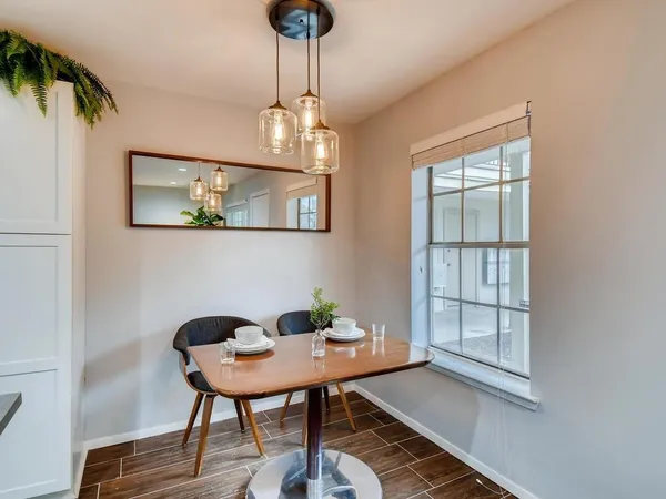 a view of a dining room with furniture and chandelier