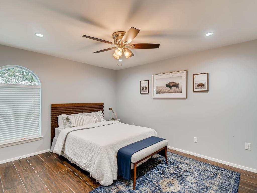 910 Duncan Lane, Unit 16 Austin, TX 78705 - Photo 10 of 15 a bedroom with a bed and a window