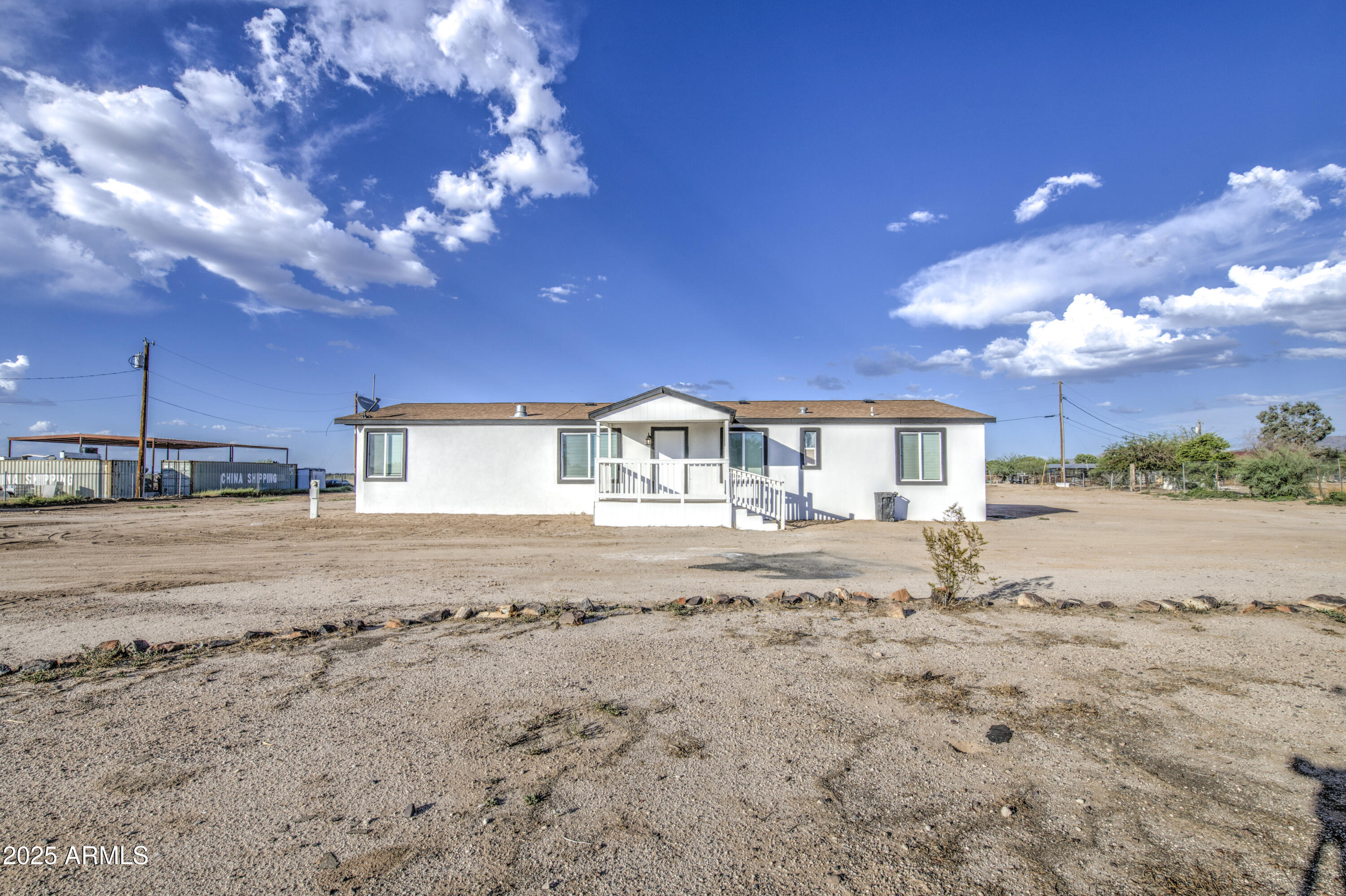 19954 West Teepee Road Buckeye, AZ 85326 - Photo 2 of 46 a view of a house with a yard