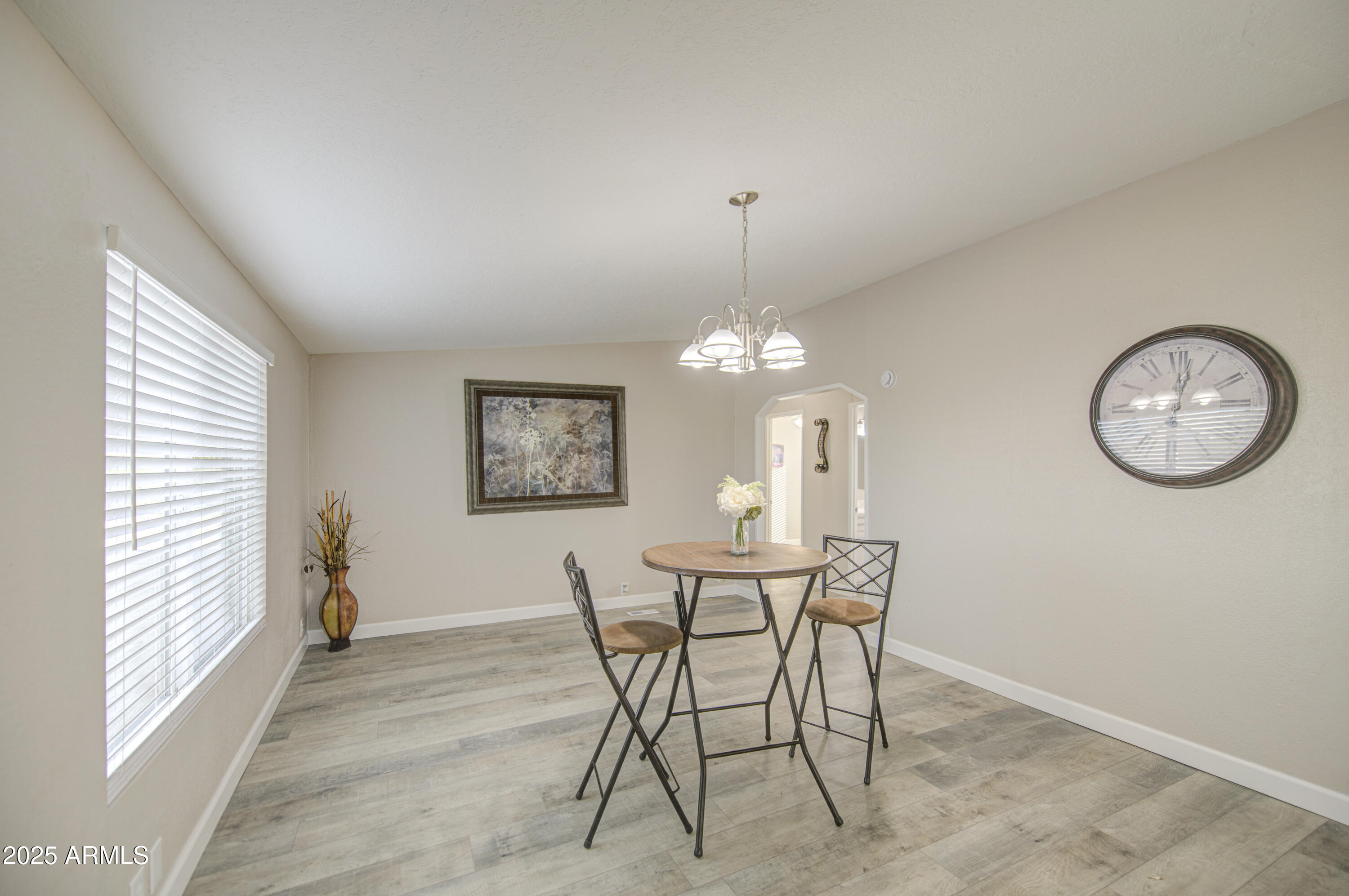 19954 West Teepee Road Buckeye, AZ 85326 - Photo 22 of 46 a view of a dining room with furniture and a chandelier